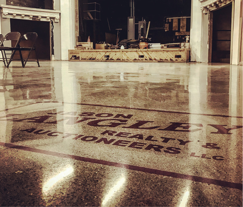 Jason Langley Realty & Auctioneers logo on a glossy polished concrete floor in a historical building in Washington Court House, Ohio.