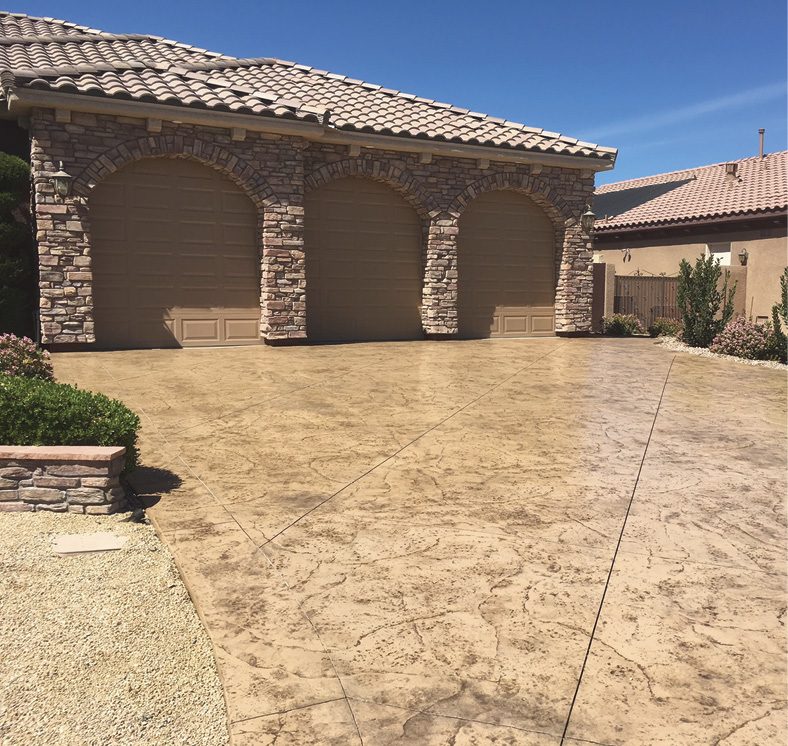 After installing Westcoats TC-6 overlay tinted with Sahara stain and antiqued with a Mocha-colored release, contractor Mike McAnulty stamped this driveway with an Old Granite pattern from Proline. It was then sealed with Arizona Polymers Poly 250.