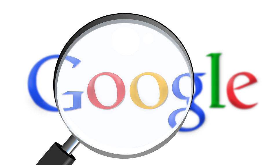 Google logo with magnify glass held over it.