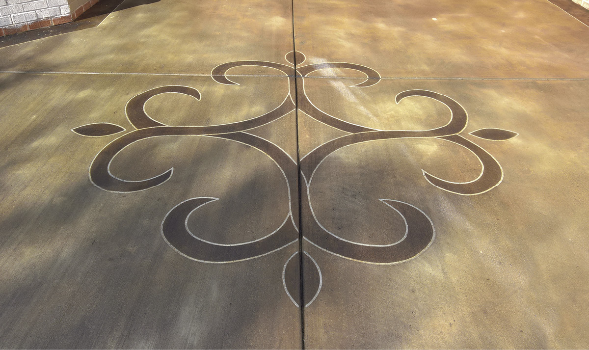 Stained and saw cut concrete with a medallion stained a richer color.