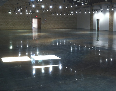 Huge epoxy floor with a brilliant shine reflecting the over head lights.