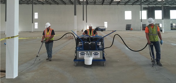 Large equipment being used to fill cracks in concrete in a timely and efficient matter