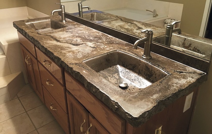 Brown multicolored concrete countertop in a bathroom with two integral sinks. Photos courtesy of Concrete In-Counters