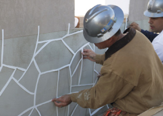 Stencil placement on a concrete wall system at Concrete Decor's Decorative Concrete Live at World of Concrete 2018.