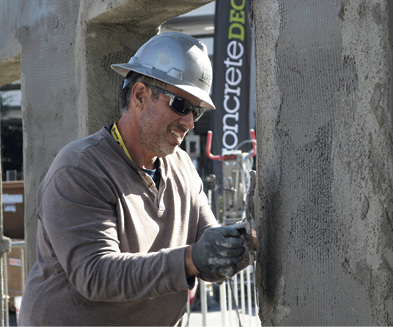 Matthew Sampson works on a wall scratch coated with Stone Edge Product.