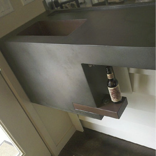 Concrete countertop with built in shelving.