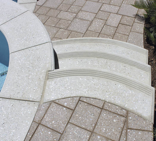 Abalone shells were the aggregates of choice to seed this poolside installation, with a grind that left the surface short of polish level to retain slip resistance. Photo courtesy of The Green Scene Landscaping and Swimming Pools