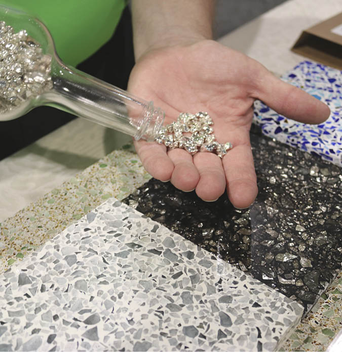 During a recent World of Concrete, a Heritage glass representative displays his companys silver-coated aggregate. Photo from Concrete Decor archives