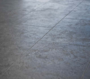 Up close look at a concrete floor with control joints.