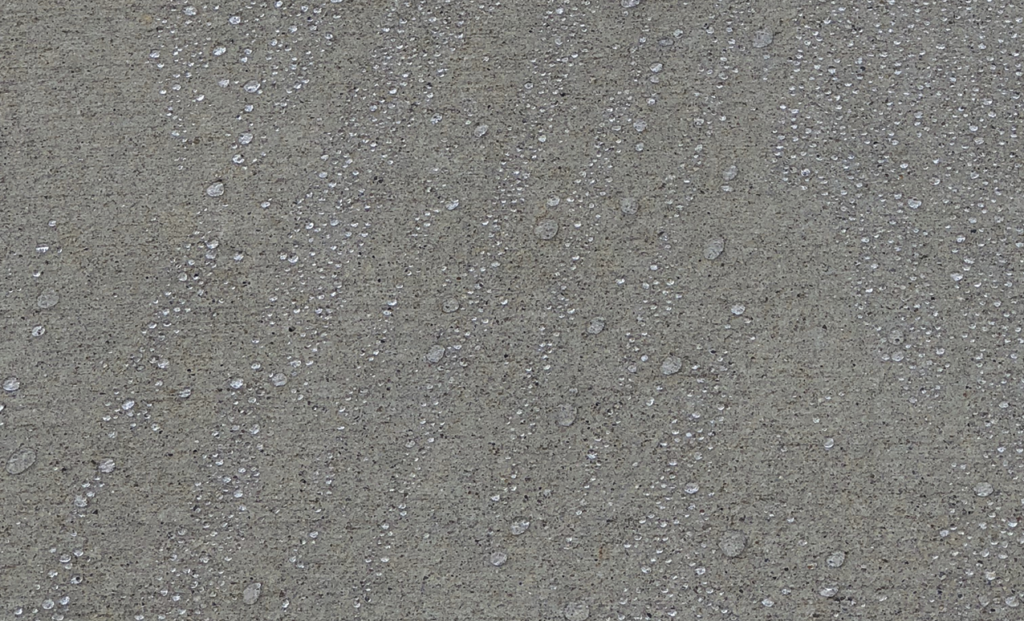 penetrating water-based sealer creating beads on water on concrete