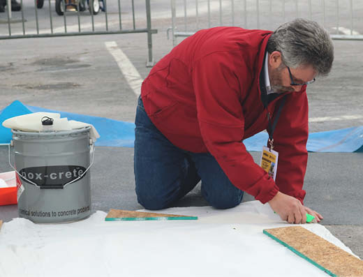 Marty O'Mara works on the concrete sealer application by Nox-Crete