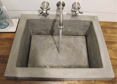 Concrete sink with an invisible drain on the outer edge. 