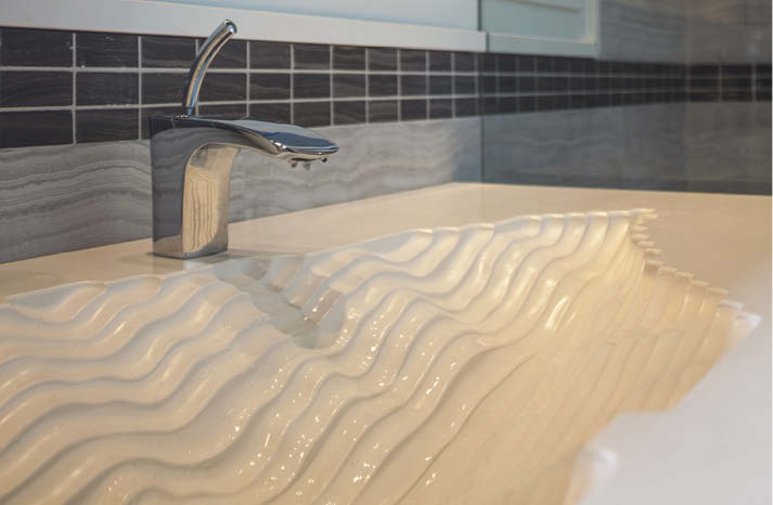 As part of the expanded project, Ian Wyndlow of Liquid Stone Studios in Ladysmith, British Columbia, says he was given carte blanche to design a one-of-a-kind bathroom vanity with an integral sink.