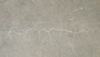 Although the crew used a standard technique and a 2-by-4 to screed the surface, their mistake was they got on the slab too early with the trowels. The areas that were troweled where the screed had already consolidated the concrete closed slightly more, trapping the water below. This led to the delamination in the shape of the screed pressure.