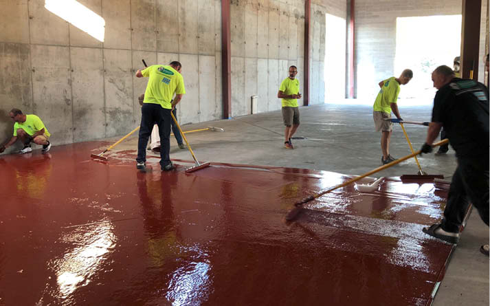 Installers placing polyaspartic floors.