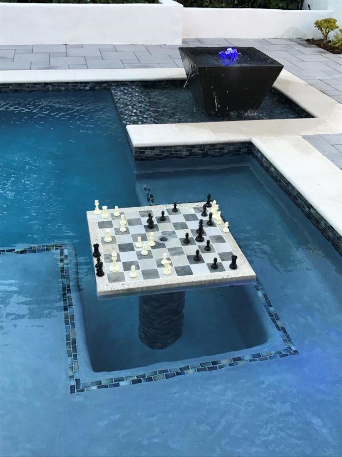Concrete Chess Table in the middle of an outdoor pool