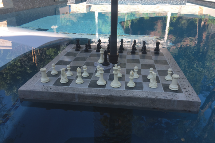 Concrete chess table in a swimming pool