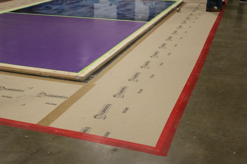 Trimaco FloorShell ProBoard, a heavy-duty yet lightweight surface protector used in the shows workshop zones, is a breathable, reusable, leak- and impact-resistant floor covering made from recycled fibers.
