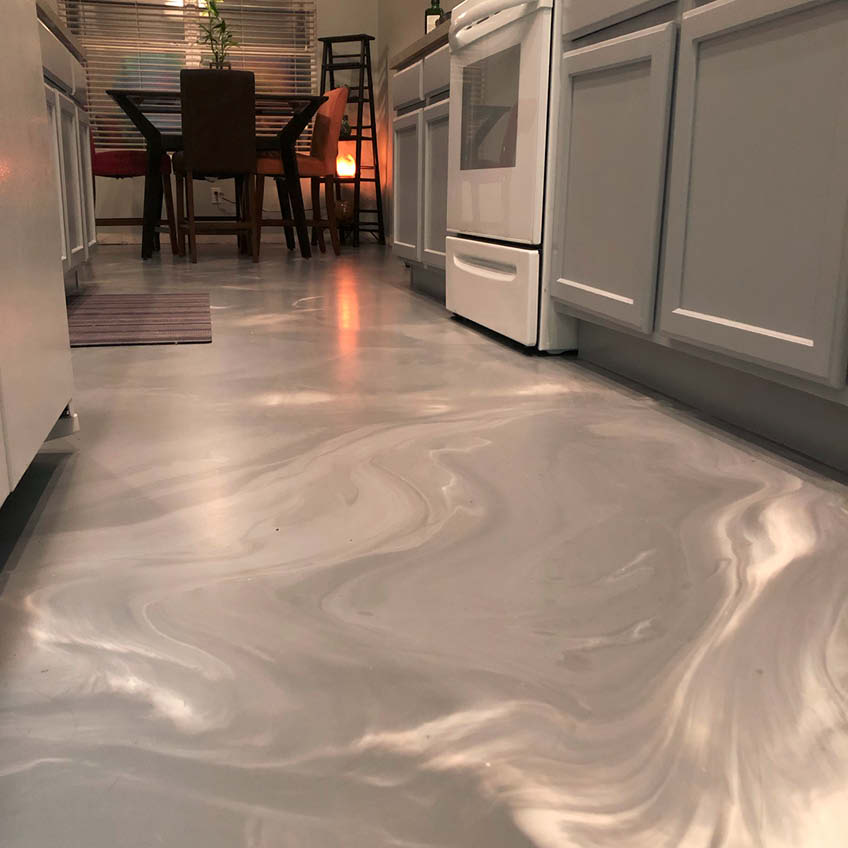 A glamour shot of a epoxy coated floor in a sleek and modern kitchen.