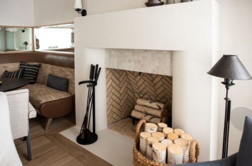 A concrete fireplace with clean, geometric lines that give the space a modern feel.