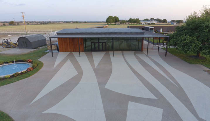 Large geometric patterns on concrete in front of a pool house.
