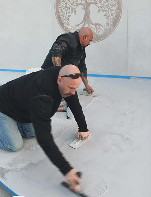 Applying a floor coat to concrete to give a smooth look.