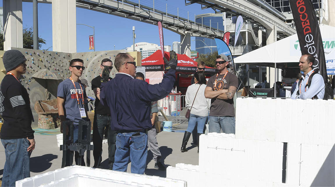 A representative of Fox Blocks speaks with attendees at Decorative Concrete LIVE! on the benefits of insulated concrete forms (ICF) construction.