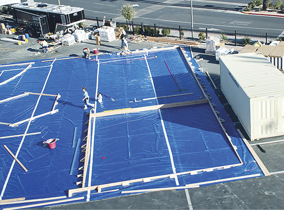 A vapor barrier by Viper II is placed on the parking lot before concrete is poured.