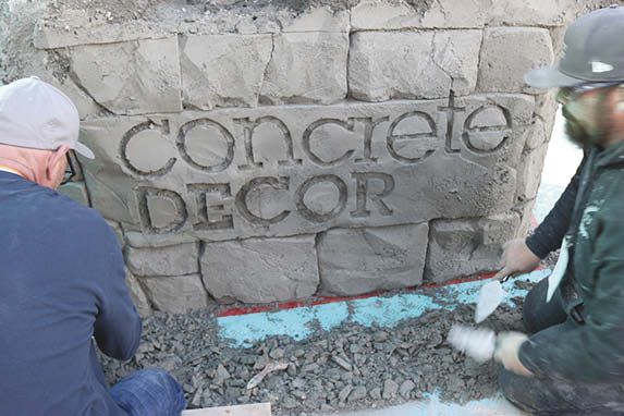 Trimaco floor protection down in front of a hand carved instance of the Concrete Decor Logo.