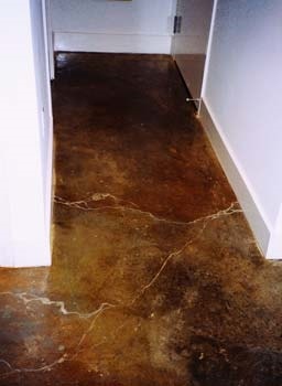 Acid stained hallway in dark browns and black cracks are emphasized giving a marbling look.