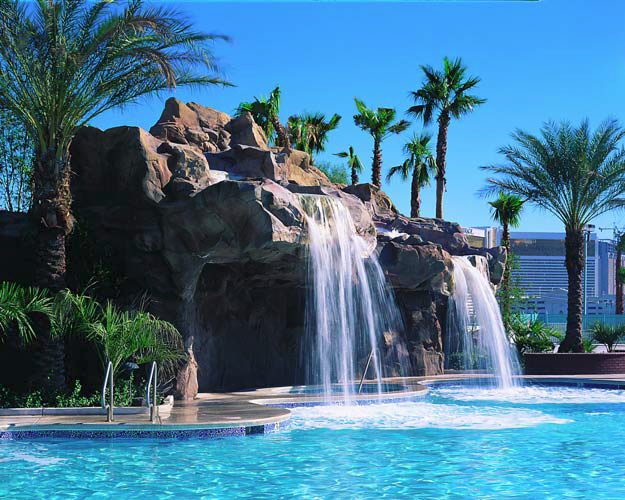 Large water features made of concrete that are found poolside make for an extravagant atmosphere.