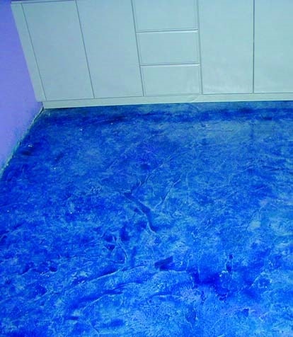 Metallic blue kitchen floor brings an electronic edge to this concrete kitchen floor.