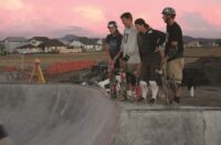 Michael Dahl and others from Airspeed Skateparks watching a skater doing tricks.