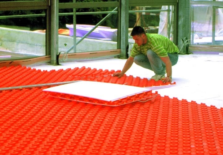 Schluter System vapor barrier can be used between the radiant heating element and the concrete.