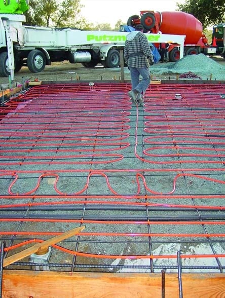 First, waterproofing goes down, then the tubes are attached. Next pea gravel concrete is used to fill up to the top of the tubes or coils.