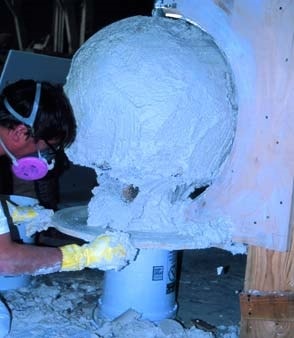 Manufacturing a concrete ball or sphere using a mold to shape the concrete.