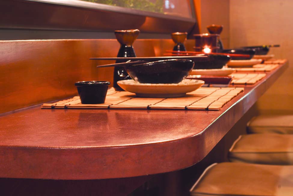 Concrete countertop creates a bar setting for a Japanese sushi restauant