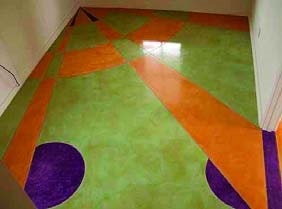 Geometric design on a concrete floor made possible with acrylic concrete stains and concrete sealer.