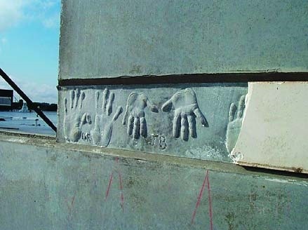 Hand print impressions in a concrete wall made from children attending a school in Florida.