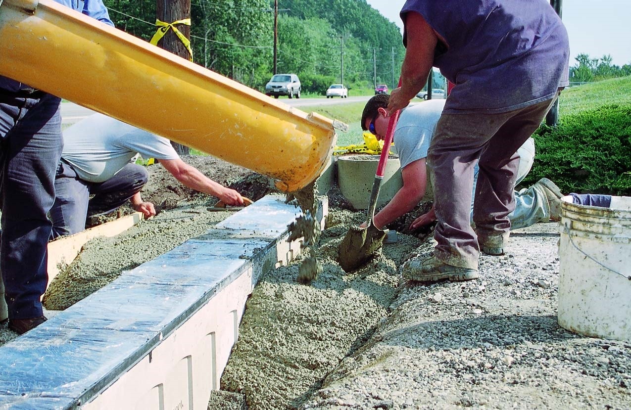 Concrete being placed within a form and around a decorative concrete form.