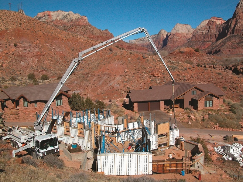Concrete pump trucks are used to fill the ICF blocks for the concrete home