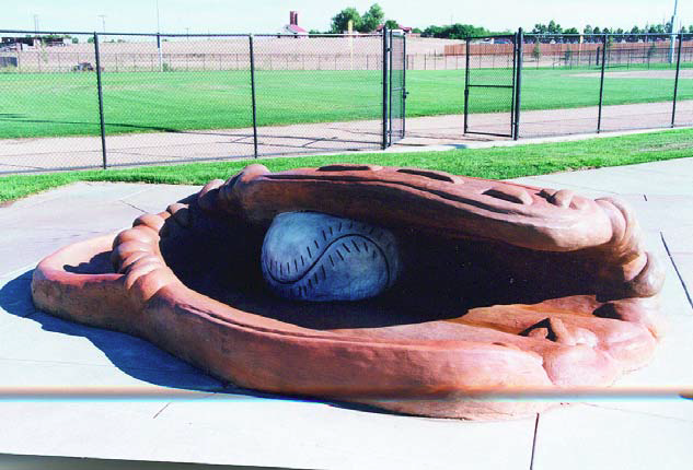 Working hand in hand with an artist,a Colorado Hardscapes crew used rebar,wire mesh and shotcrete to create this baseball glove in Aurora City Park.