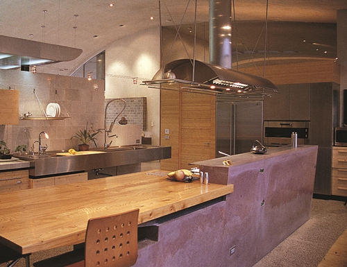 A modern kitchen with a wood and concrete countertop.