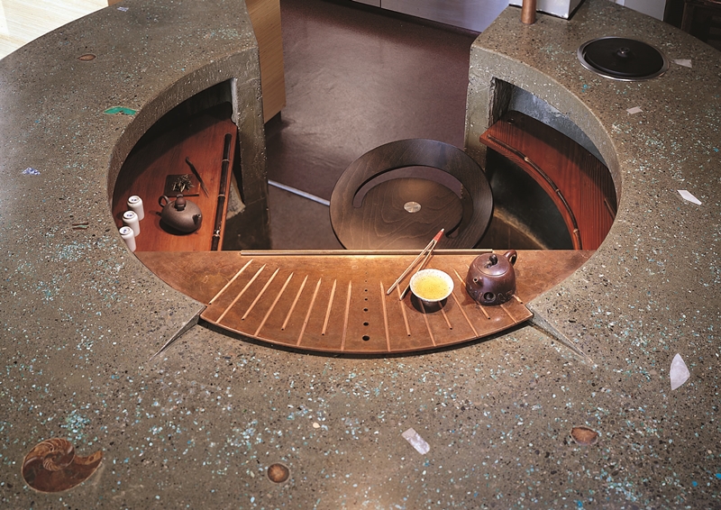 A circular concrete countertop that is in a tea show in San Francisco.