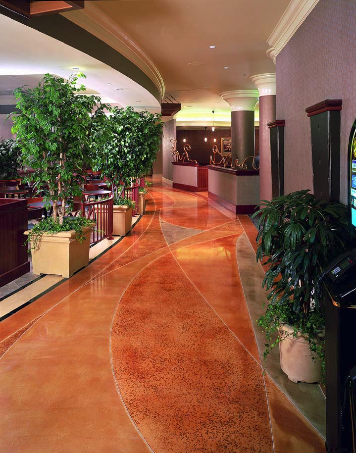 Orange concrete is used in a hotel lobby to add elements of color and sophistication.