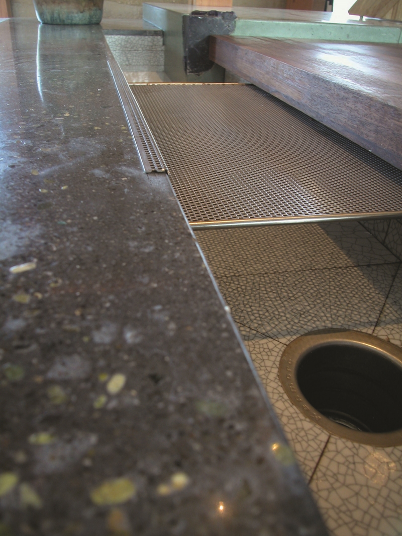Concrete countertops are perfect for adding small details like a drain board seen here.