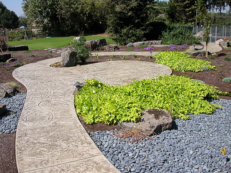 The garden pathway meanders through with this stamped concrete walkway.