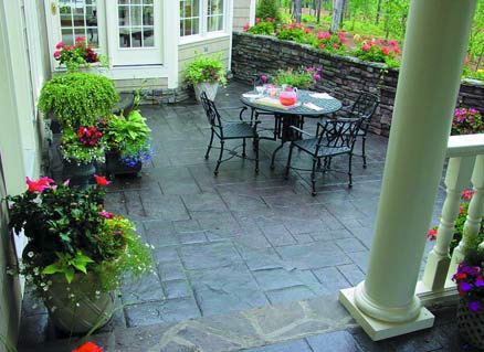 An outdoor plain concrete patio is transformed with the use of QC Construction Products vibrant color palette.