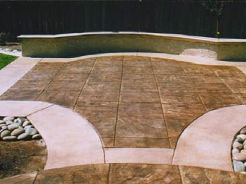 Stained concrete patio that has a different colored border creates a dynamic entertaining space.
