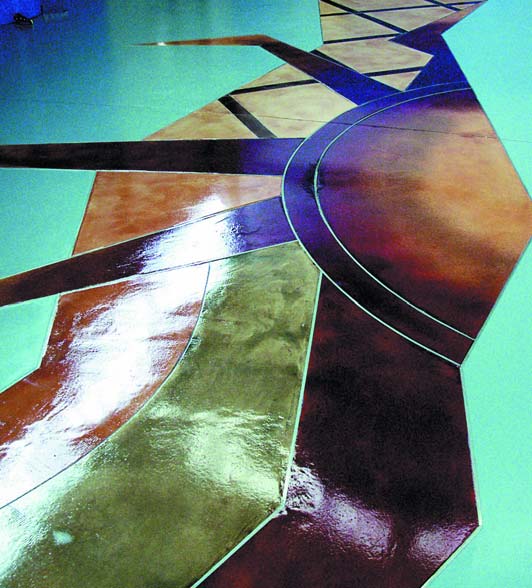 Mikhal Zambon floor design - geometric concrete floor design with blues, browns, and blacks stained concrete.